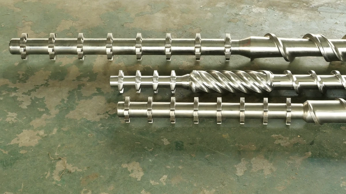 Three extruder screw sections arranged together to show their flight profiles.