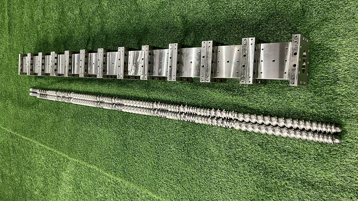 Modular twin screws displayed below a row of separate barrel sections.