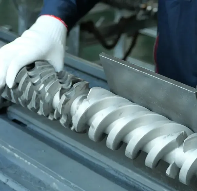 Engineer handling a custom-designed machine screw during quality inspection