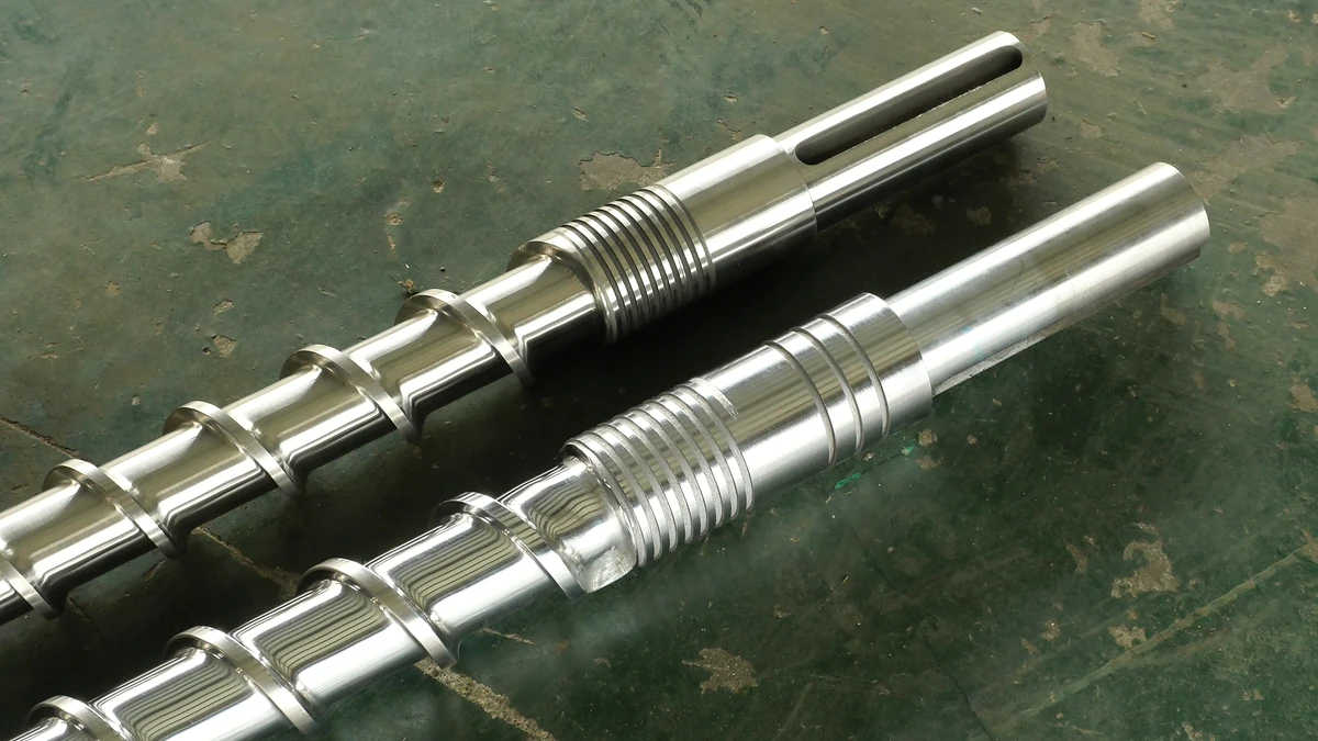 Two extruder screw drive ends showing machined slots and threaded sections.