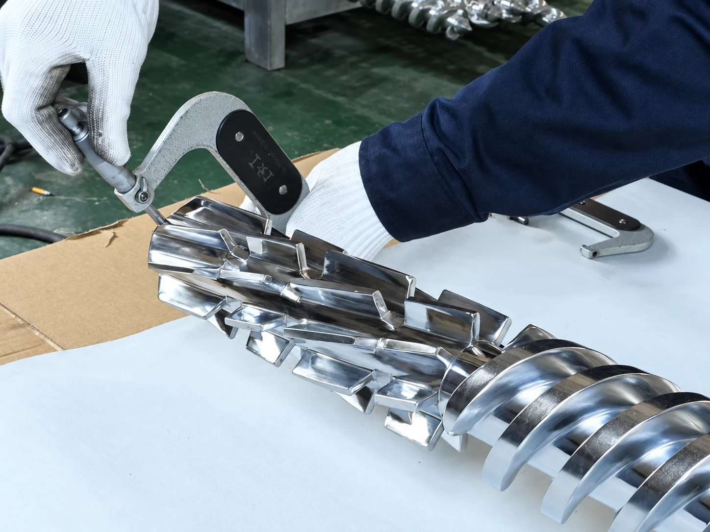 Engineer handling a custom-designed machine screw during quality inspection