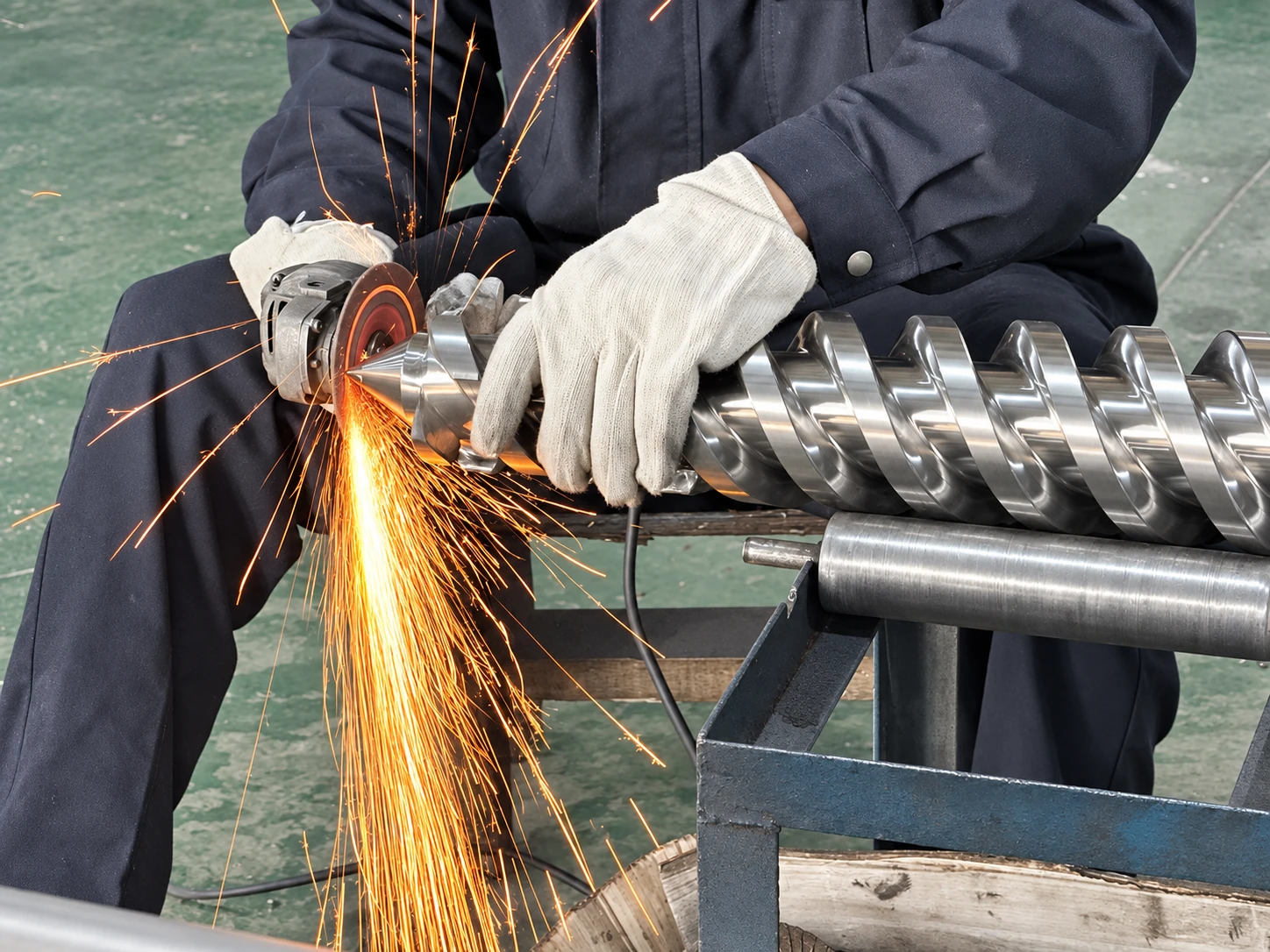 Close-up view of an industrial extruder screw with precision-machined flights