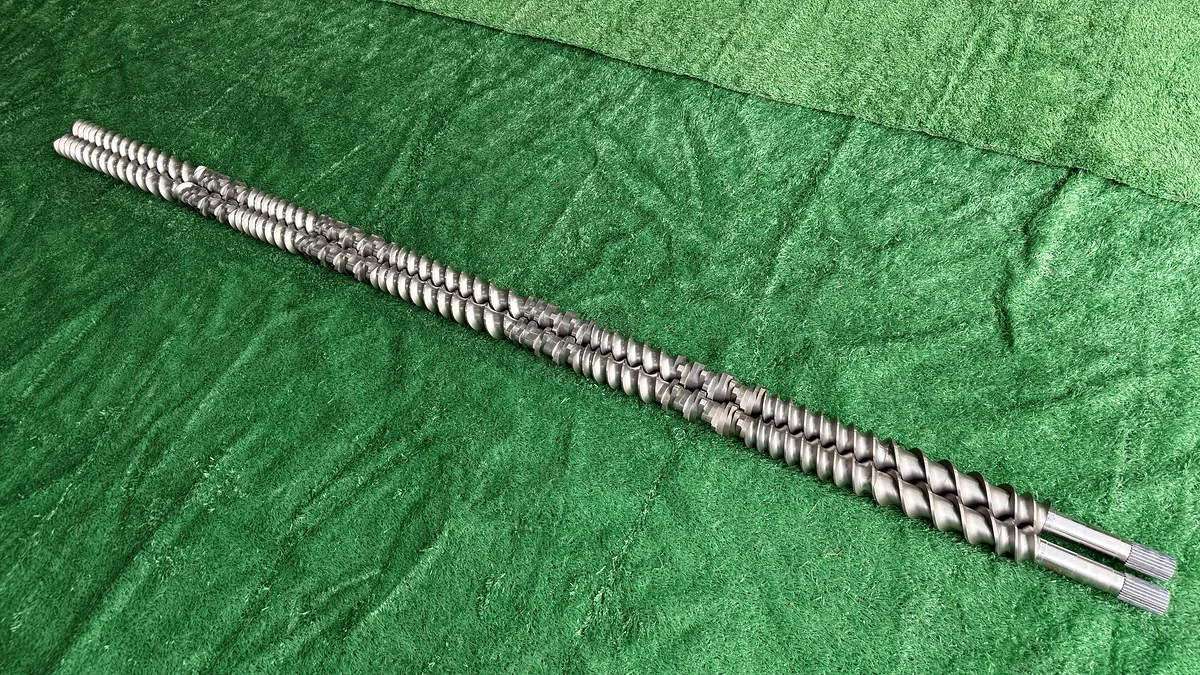 Assembled modular twin extruder screws showing conveying and mixing elements.
